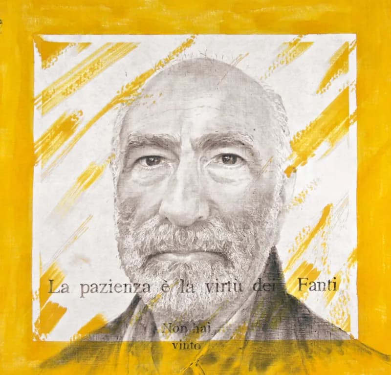 Frontal grey portrait of a bald, bearded man, within a white rectangle crossed by diagonal yellow brushstrokes and surrounded by an ochre-yellow border. Black lettering appears across the lower part of the face.